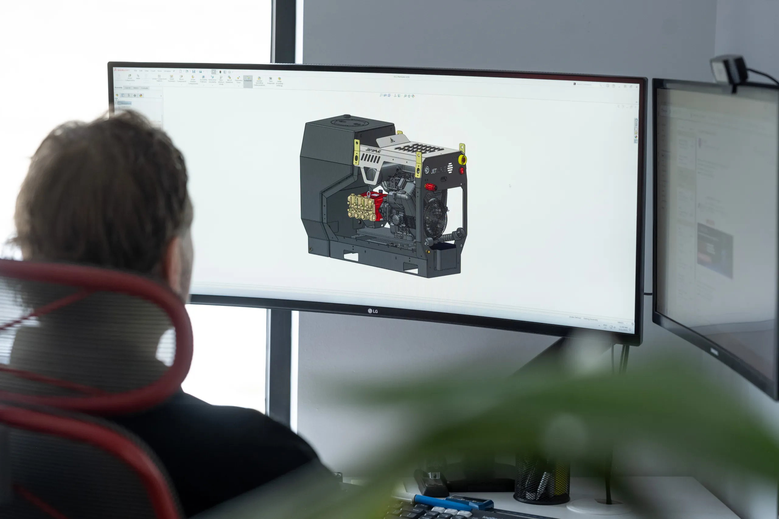 Josh working on the design of a machine in CAD software