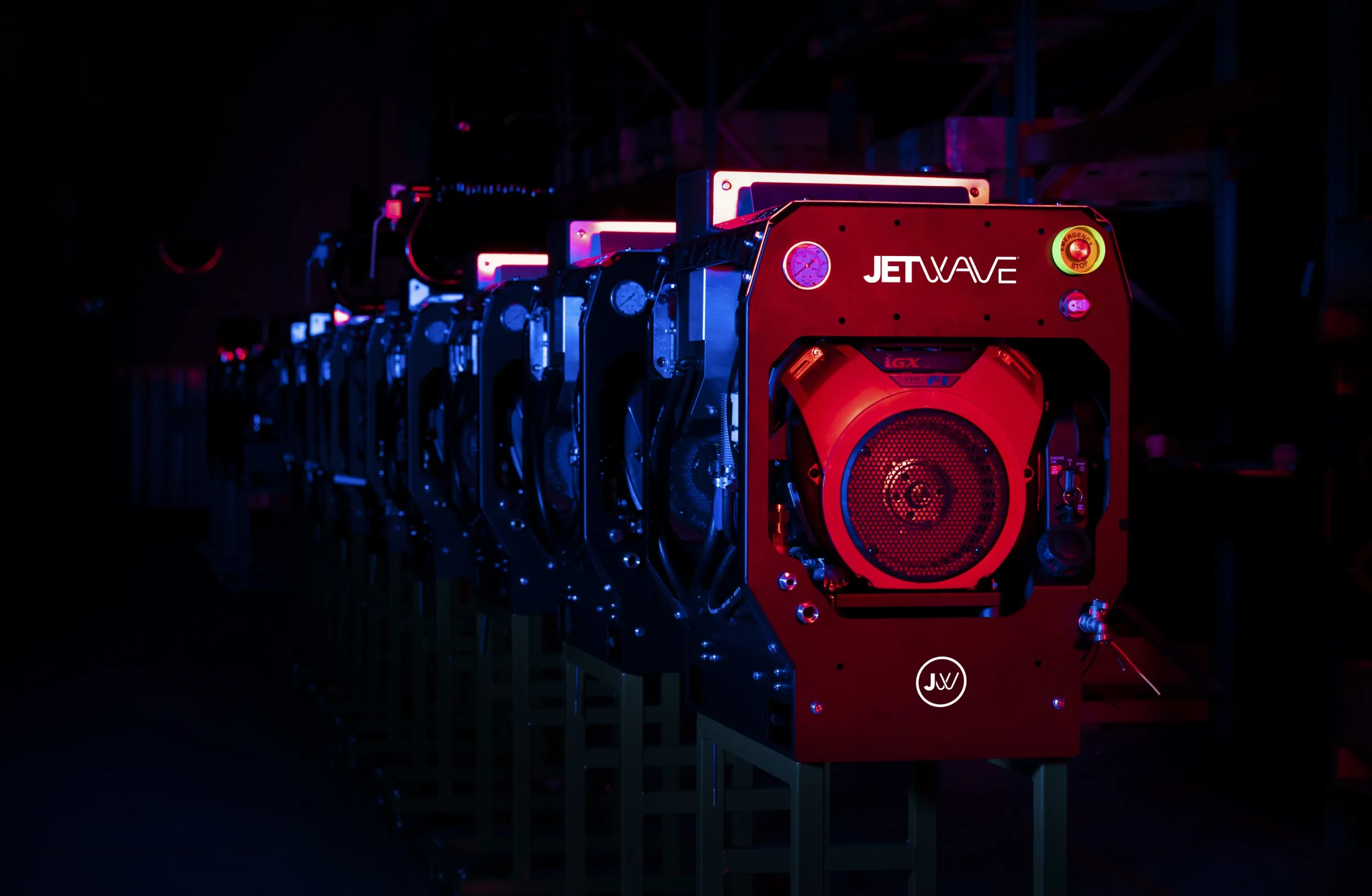 A production line of Jetwave machines with a dark background