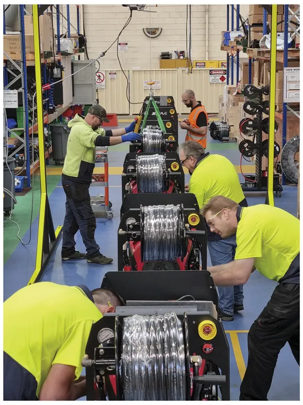 Workers working on assembling Jetwave machines on an assembly line