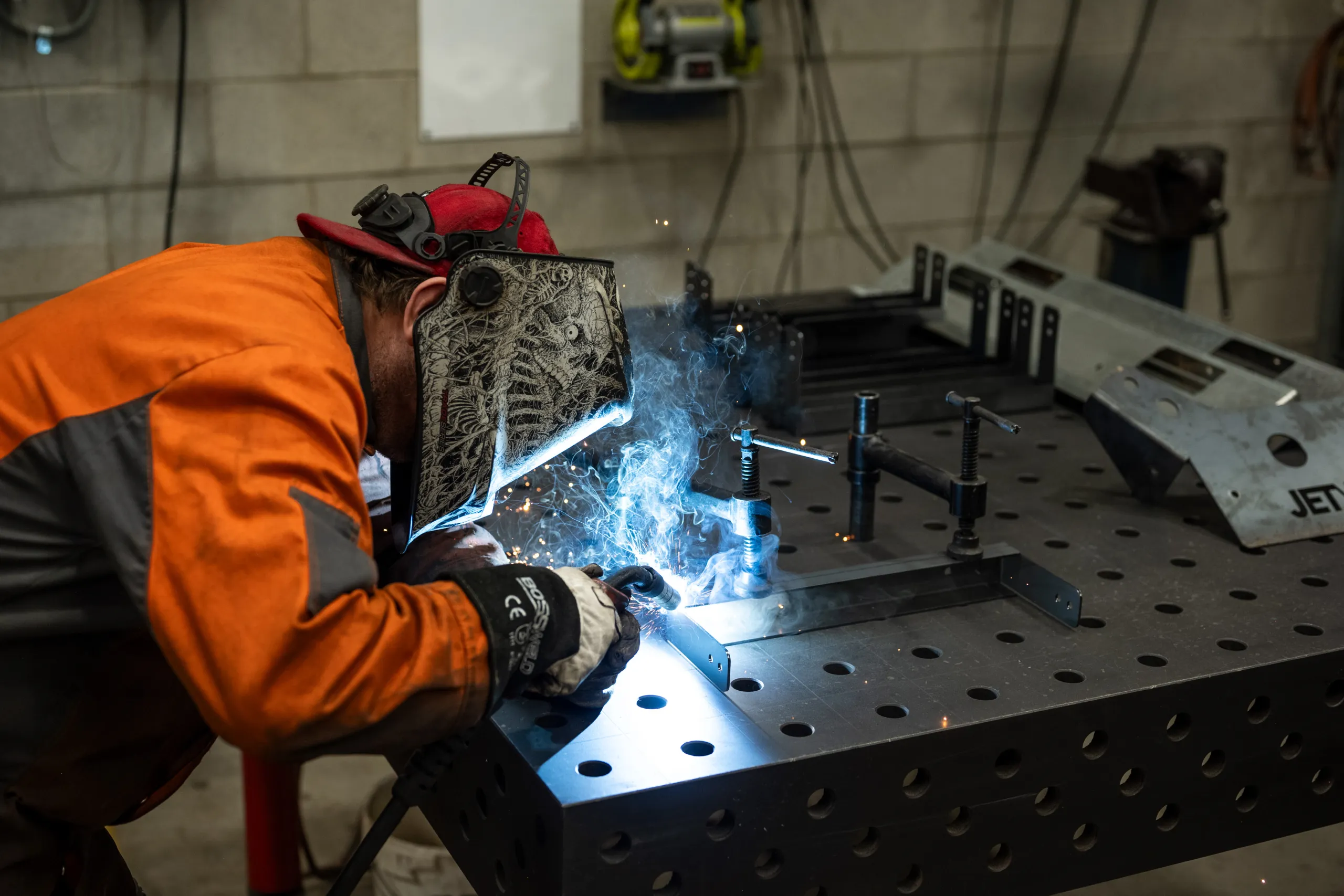 A worker welding a metal part